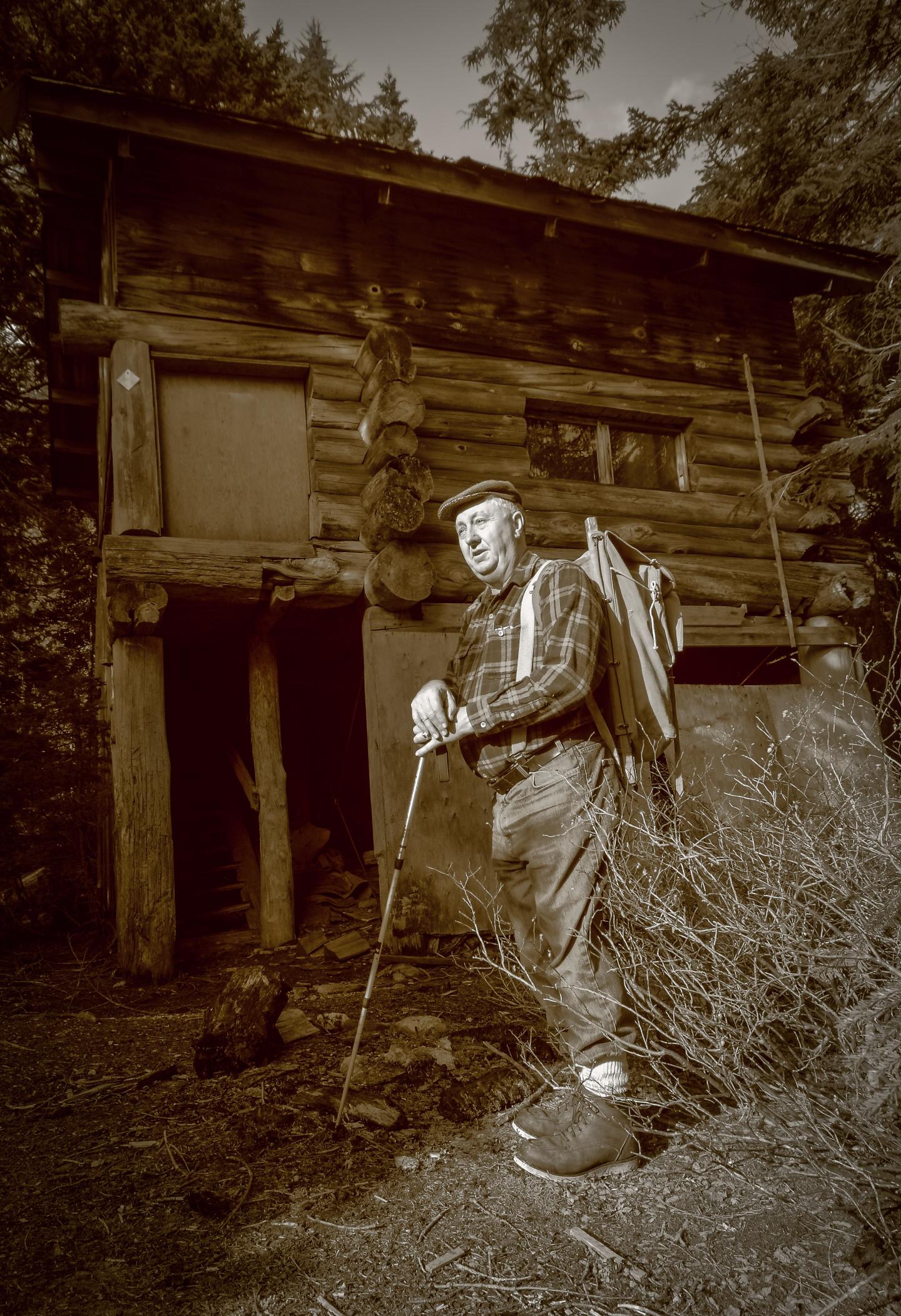 Uncle Al standing by a cabin
